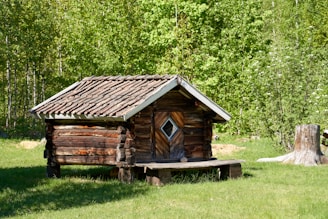 a log cabin with a bench in front of it