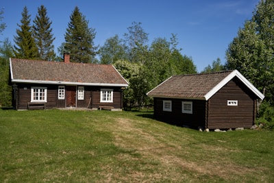 a couple of cabins sitting in the middle of a field
