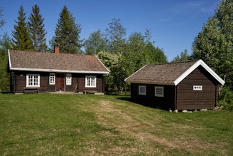 a couple of cabins sitting in the middle of a field