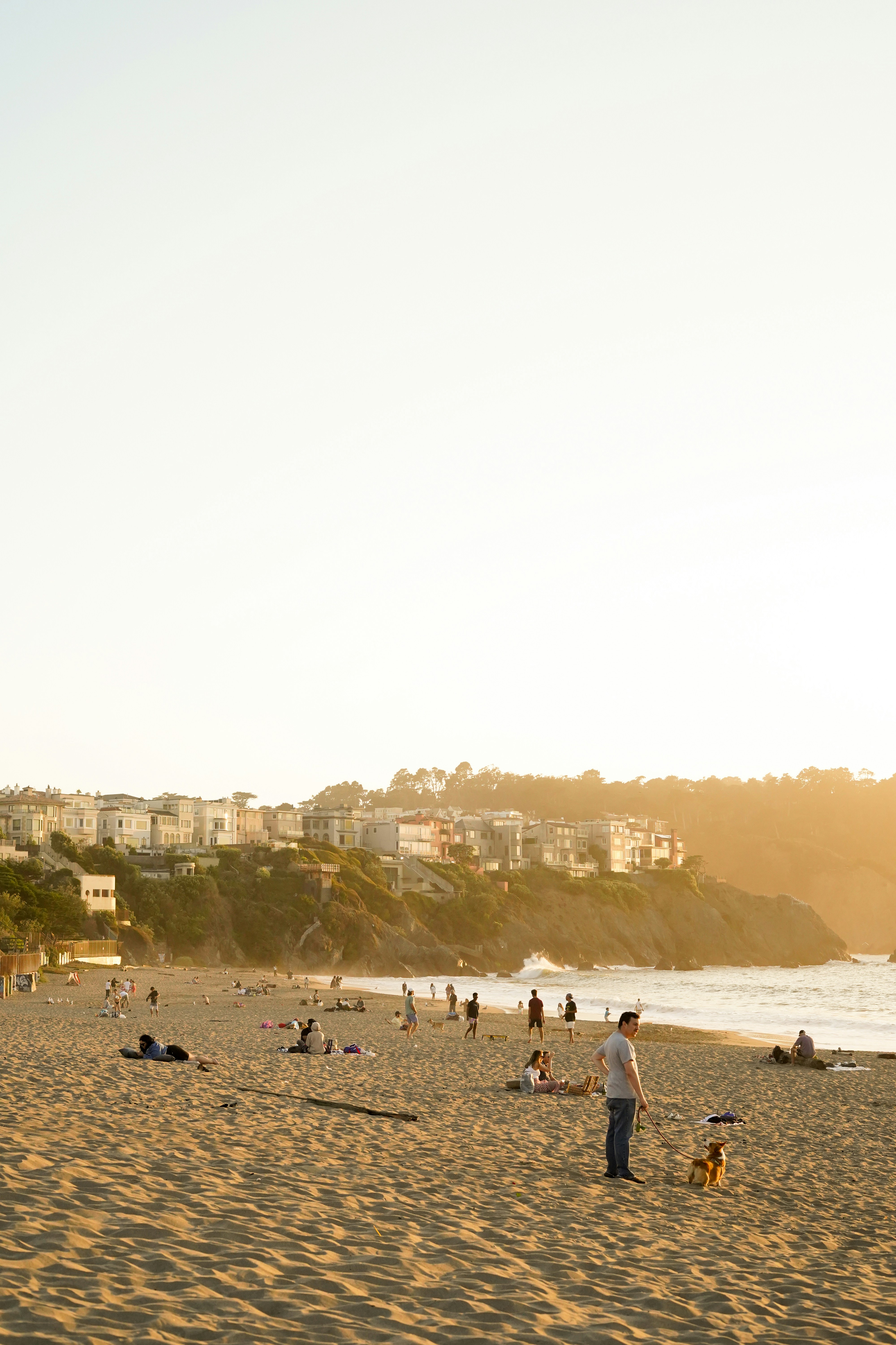 a group of people standing on top of a sandy beach