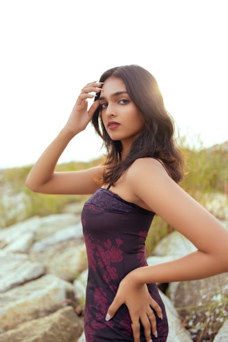 a woman in a purple dress posing for a picture