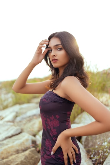 a woman in a purple dress posing for a picture