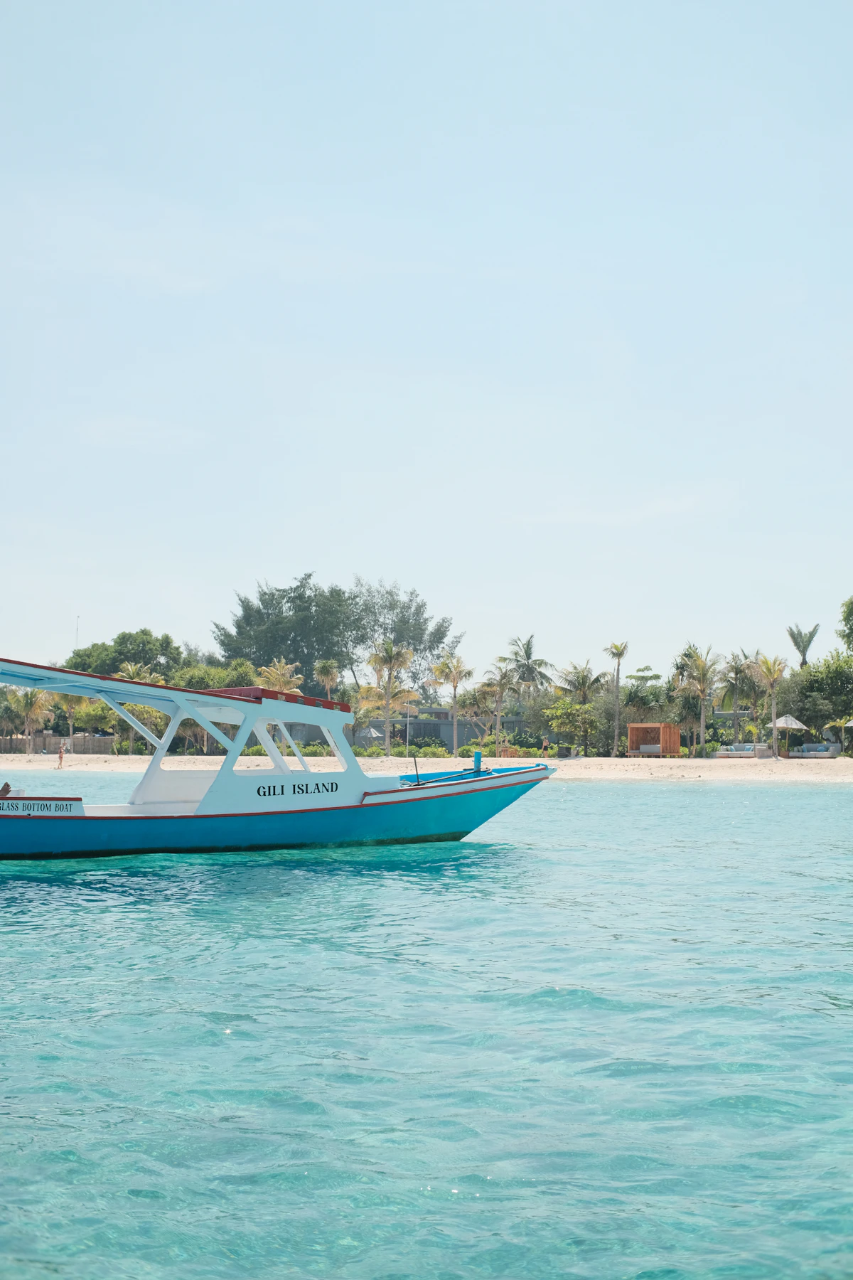 Blue boat on crystal clear water at Gili Islands Bali Indonesia