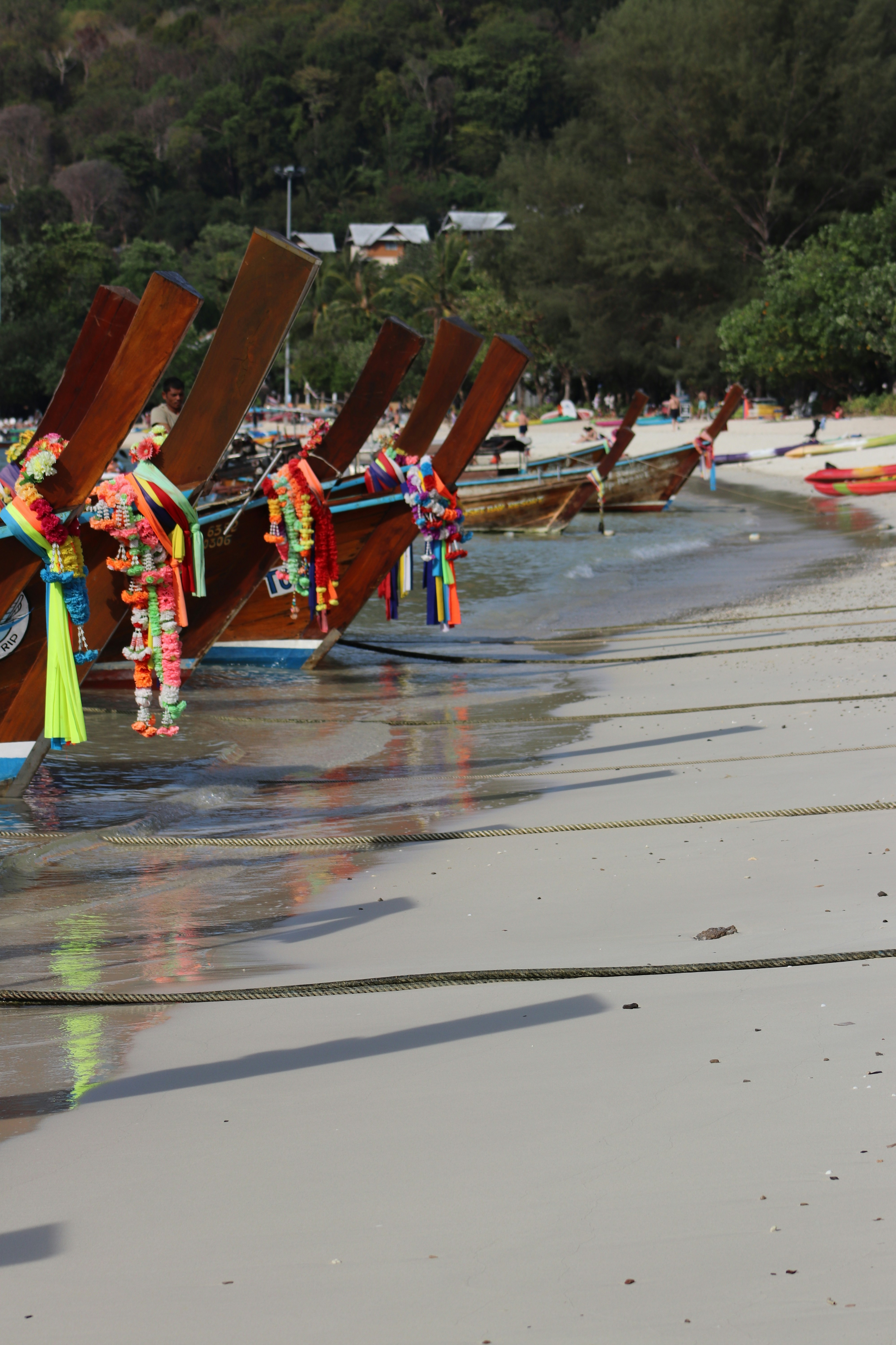 a row of wooden boats sitting on top of a beach