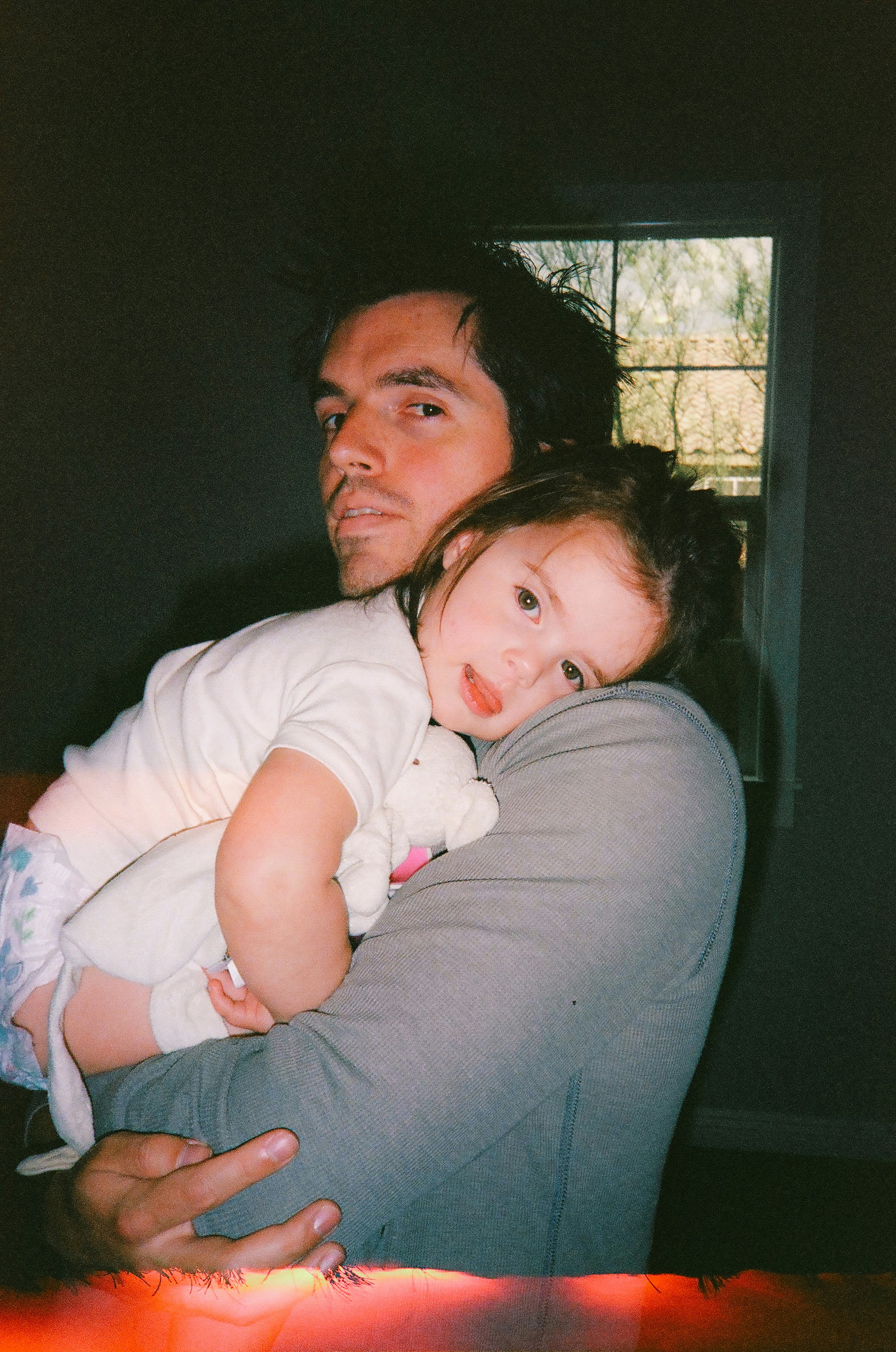 a man holding a little girl in his arms