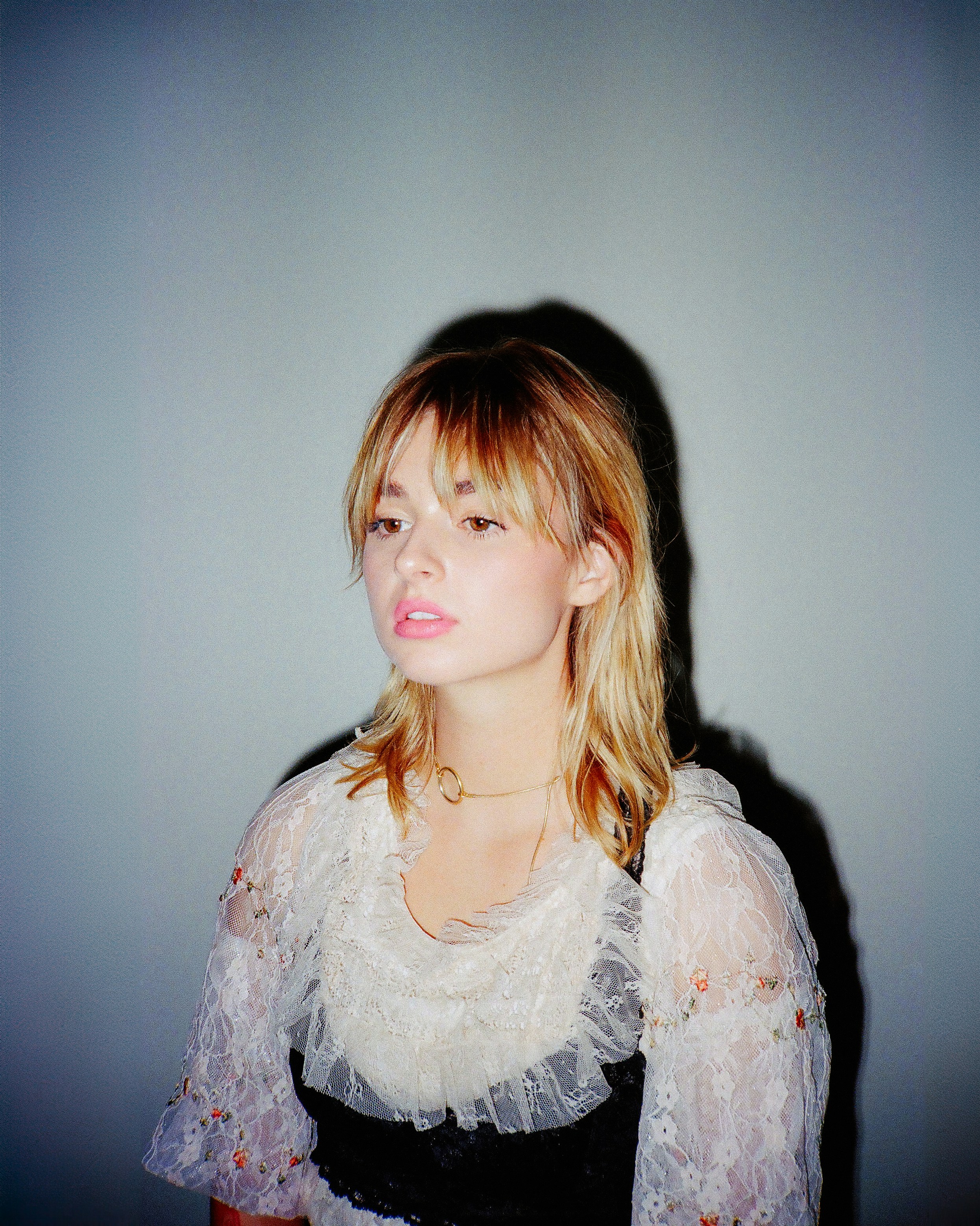 a woman in a black and white dress posing for a picture