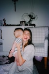 a woman holding a baby in her arms