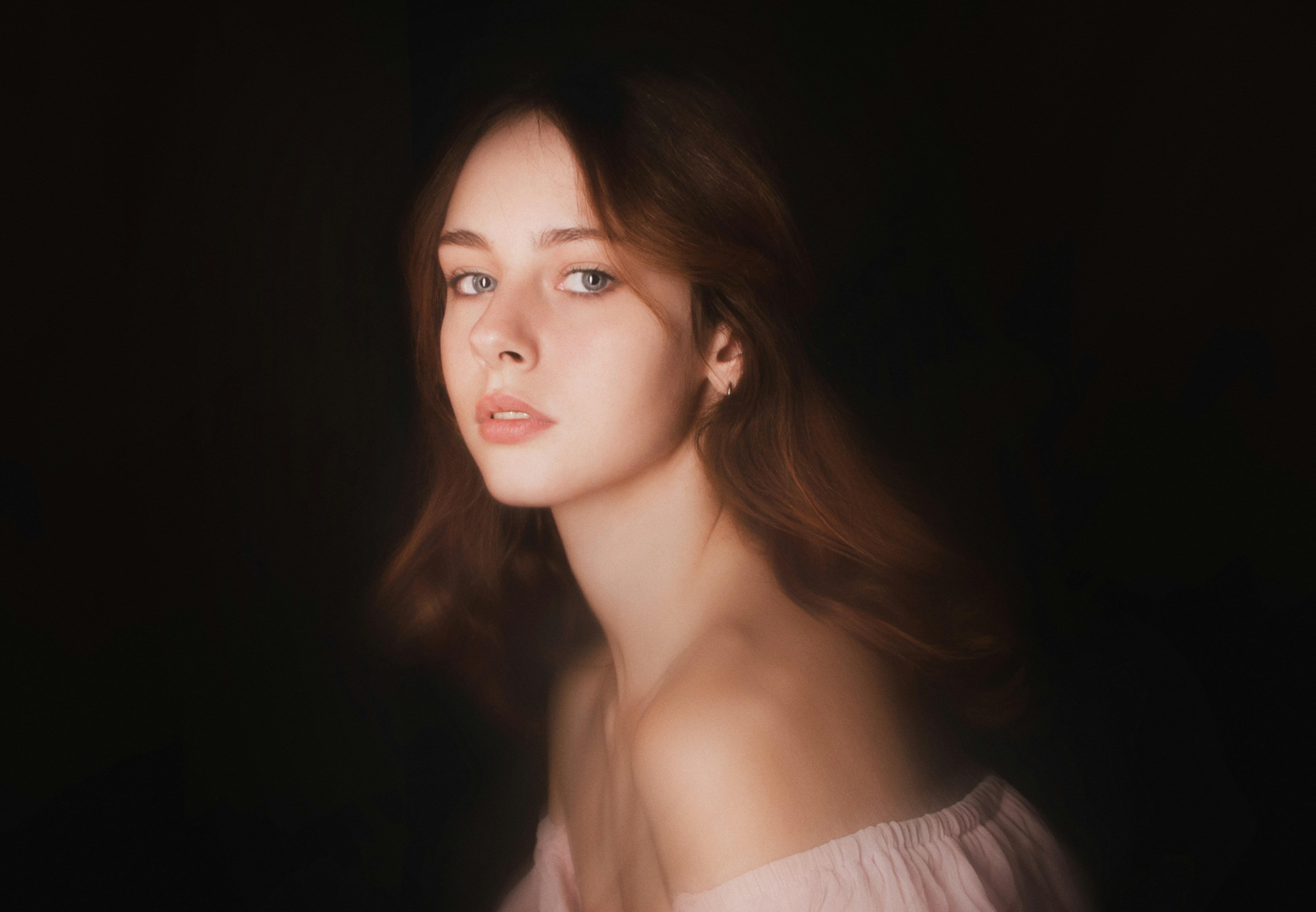 a woman in a white dress is looking off to the side