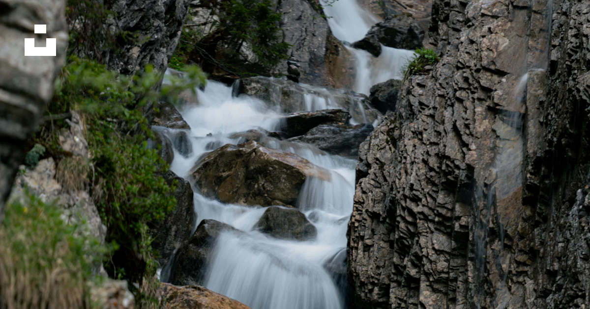 Stream Between Two Rocks A stream of water running between two large rocks photo – Free ...