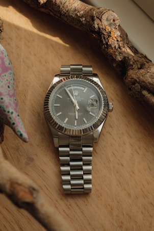 a watch sitting on top of a wooden table