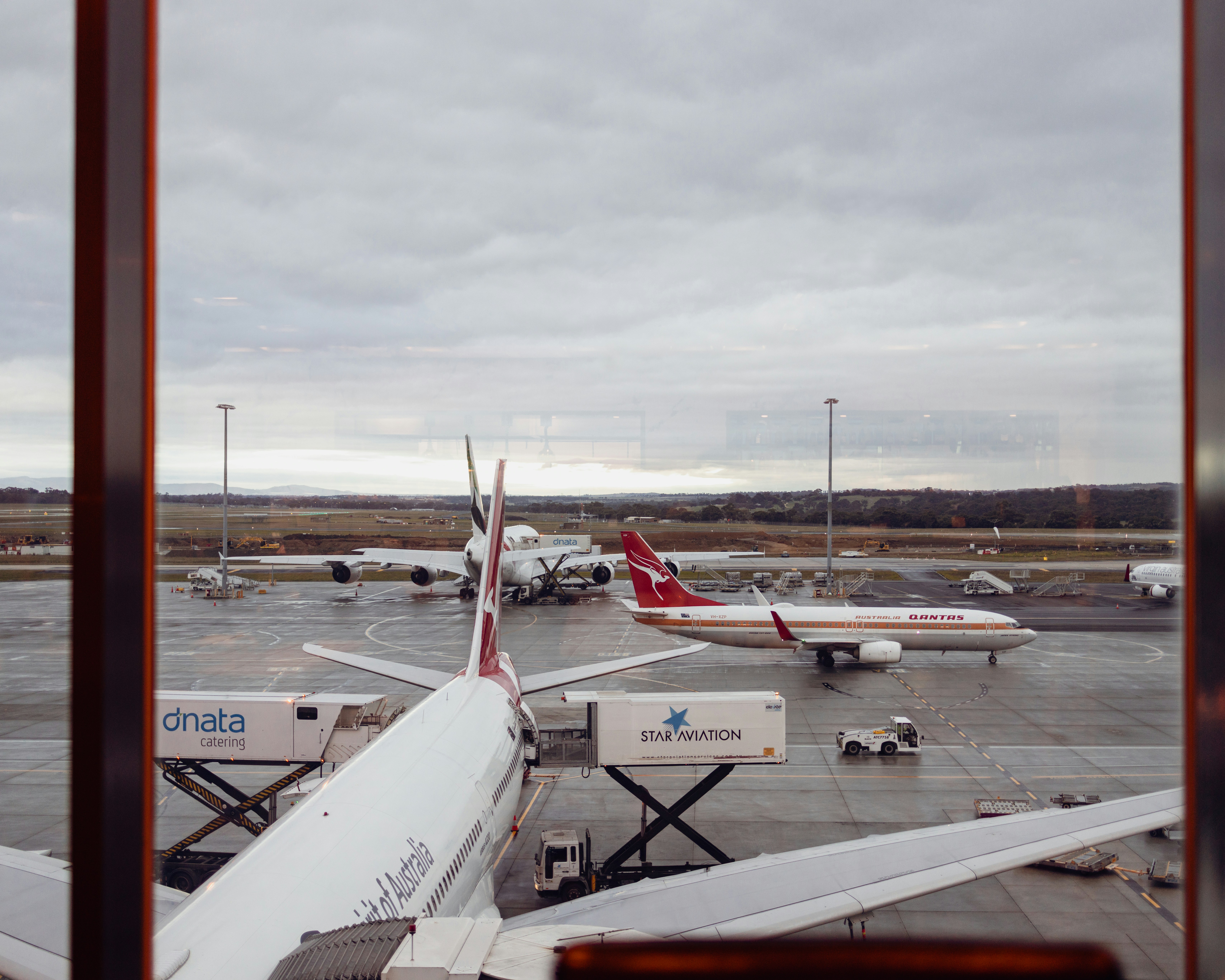 a view of an airport from a window, Qantas Retro Roo
