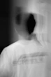 a blurry photo of a man in a white shirt
