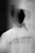 a blurry photo of a man in a white shirt