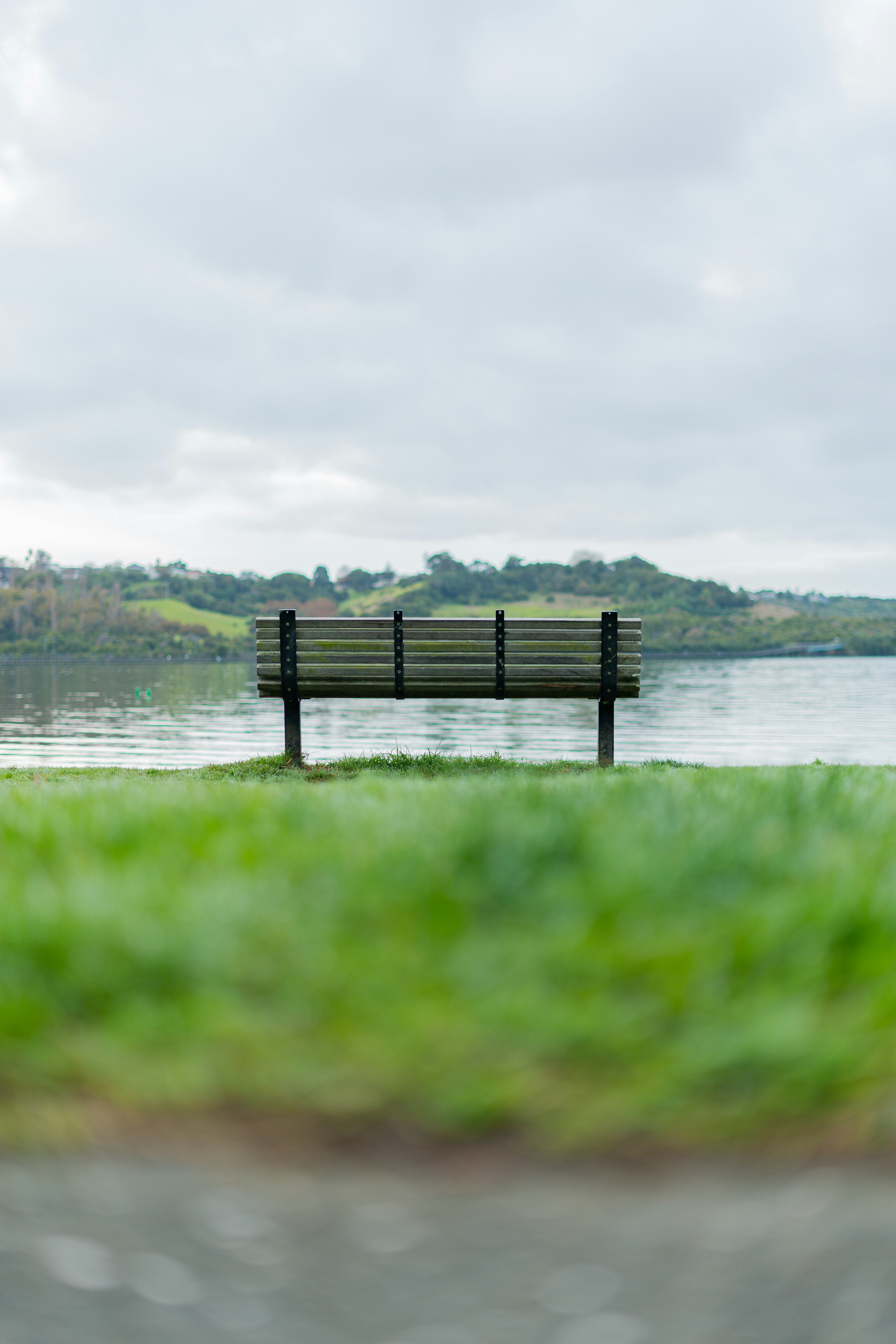 A park bench sitting next to a body of water photo – Free Bench Image ...