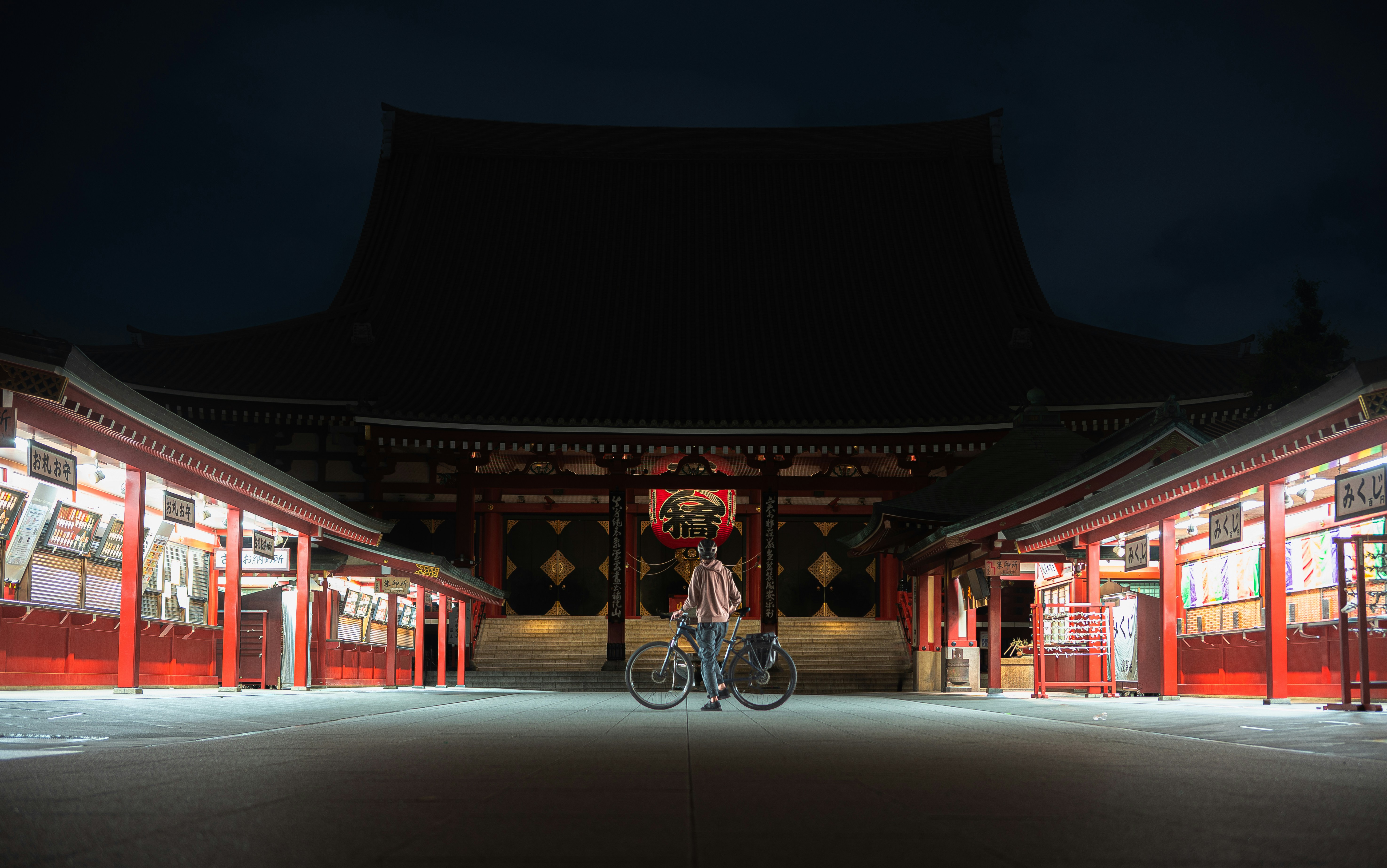 a man riding a bike in front of a building, Alone in 𖤥 Sensoji Temple, Asakusa at midnight.