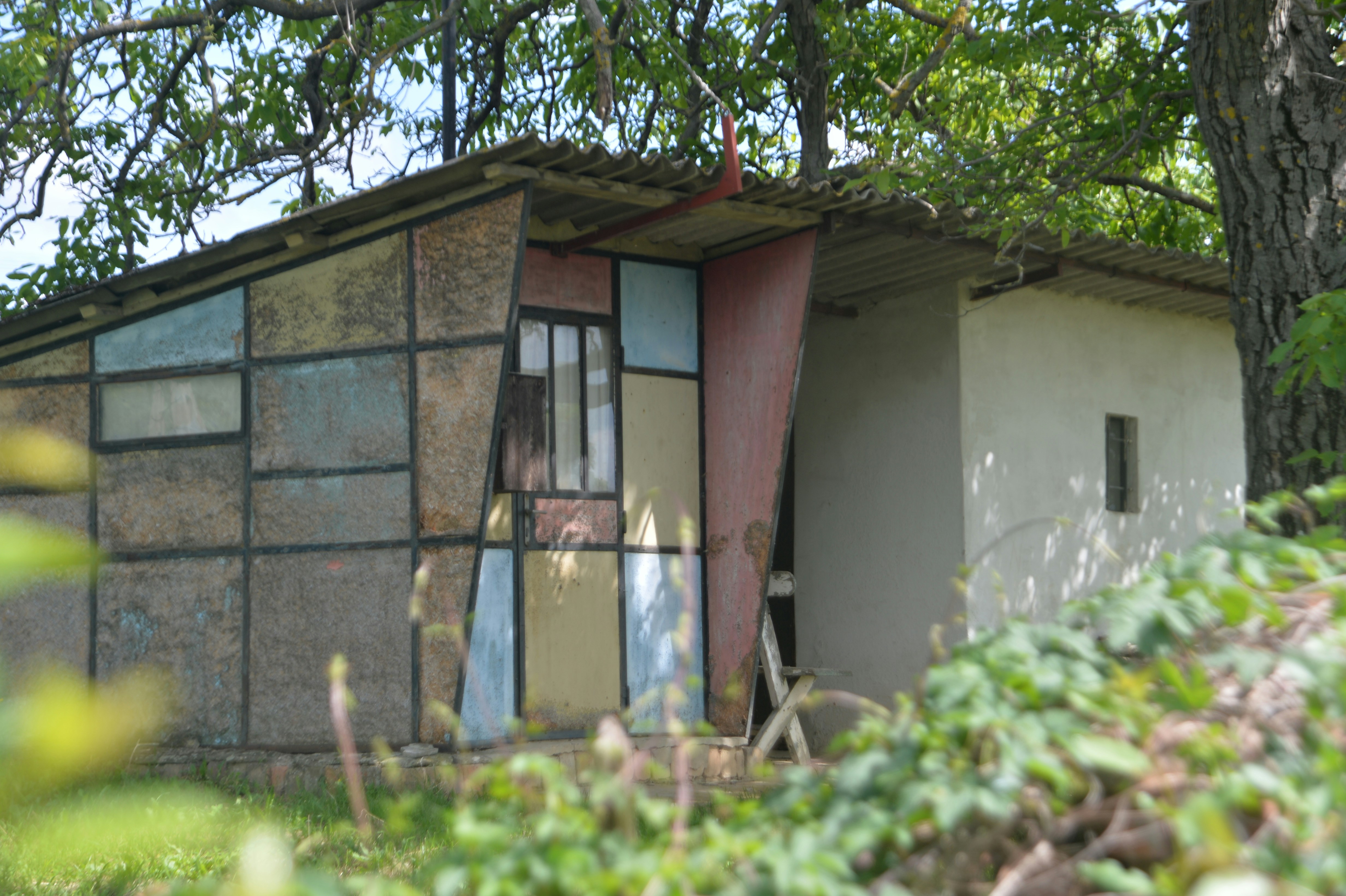a small building with a broken glass window