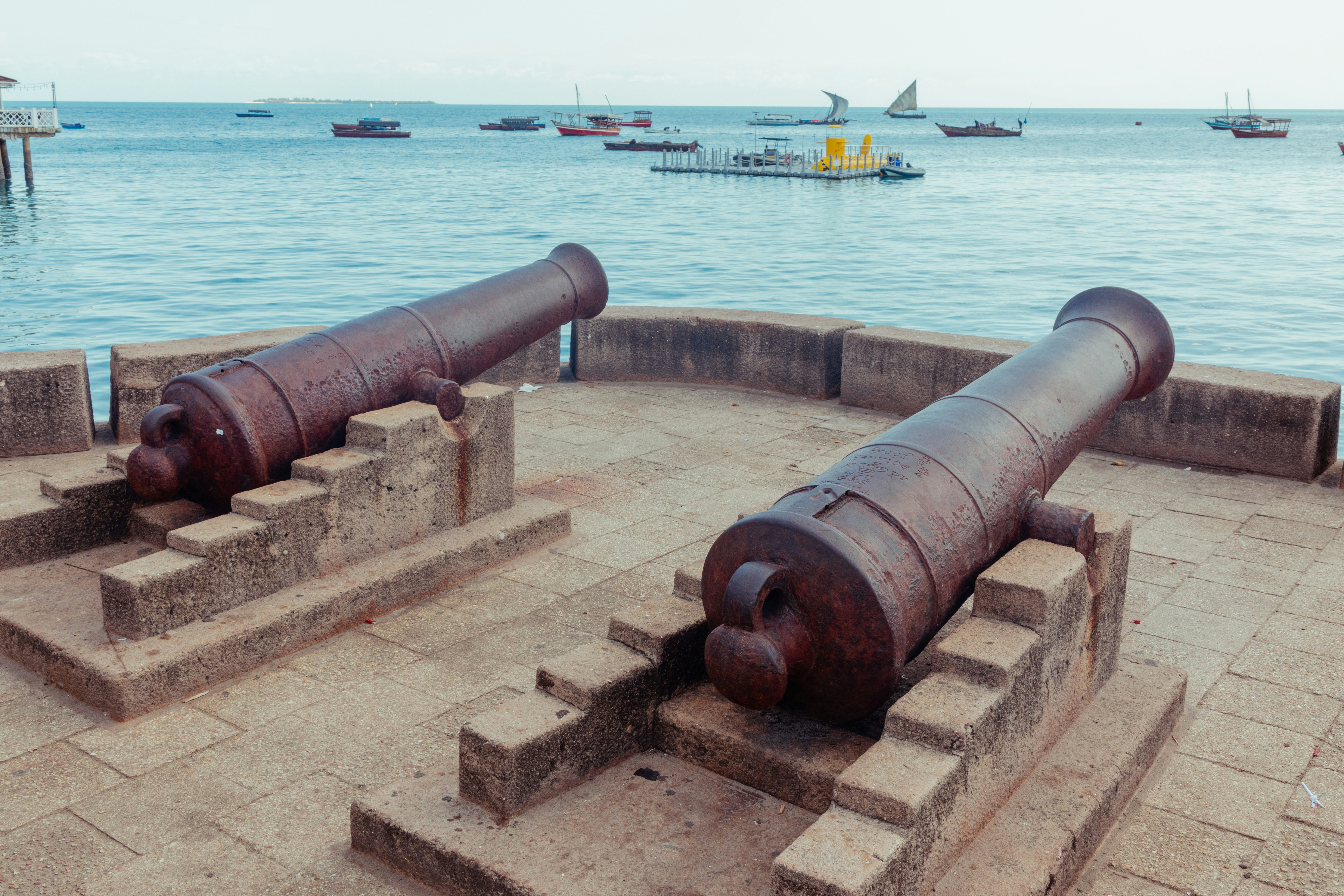 a couple of old cannon sitting on top of stone steps