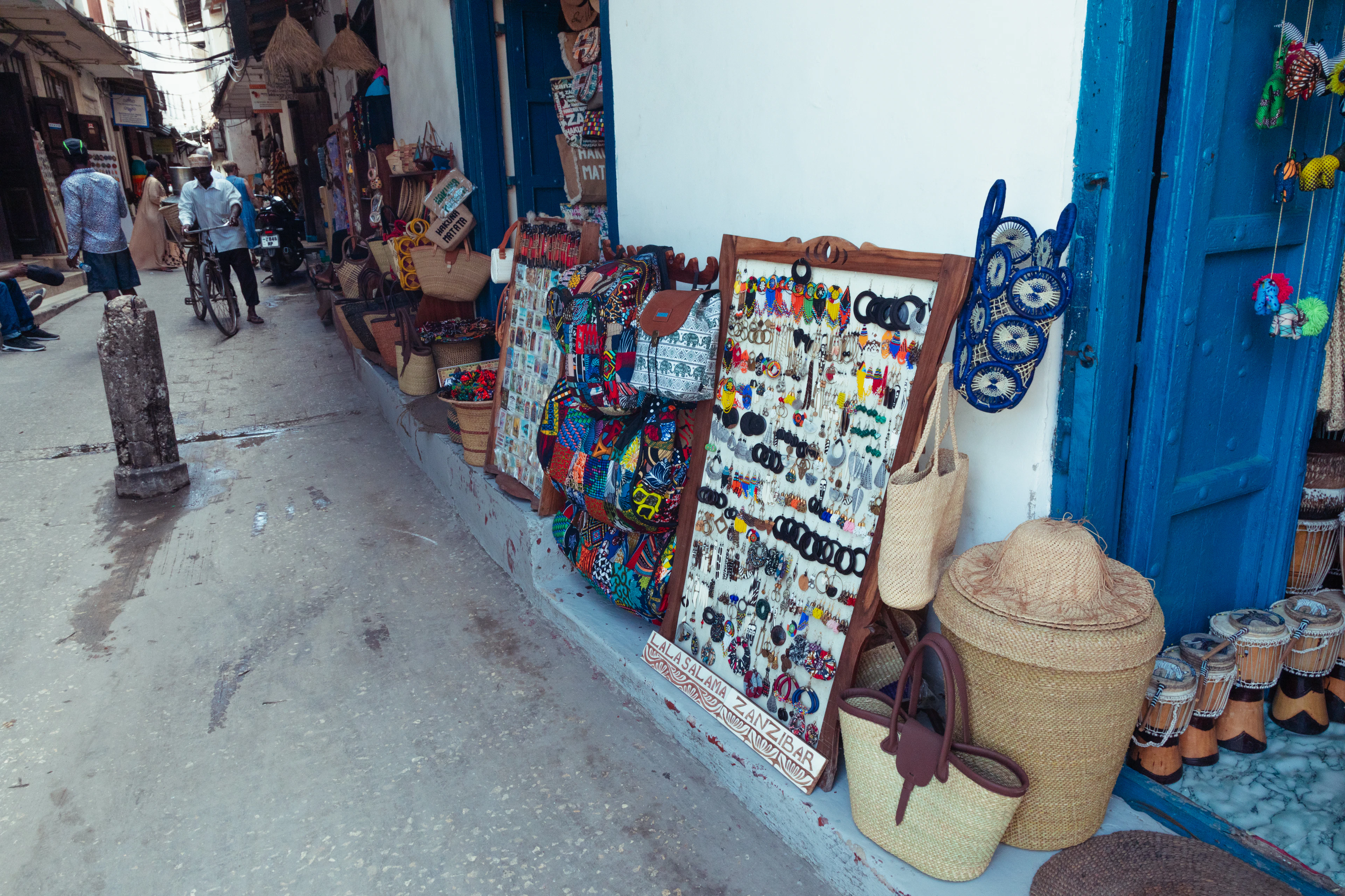 Narrow historic street lined with market stalls