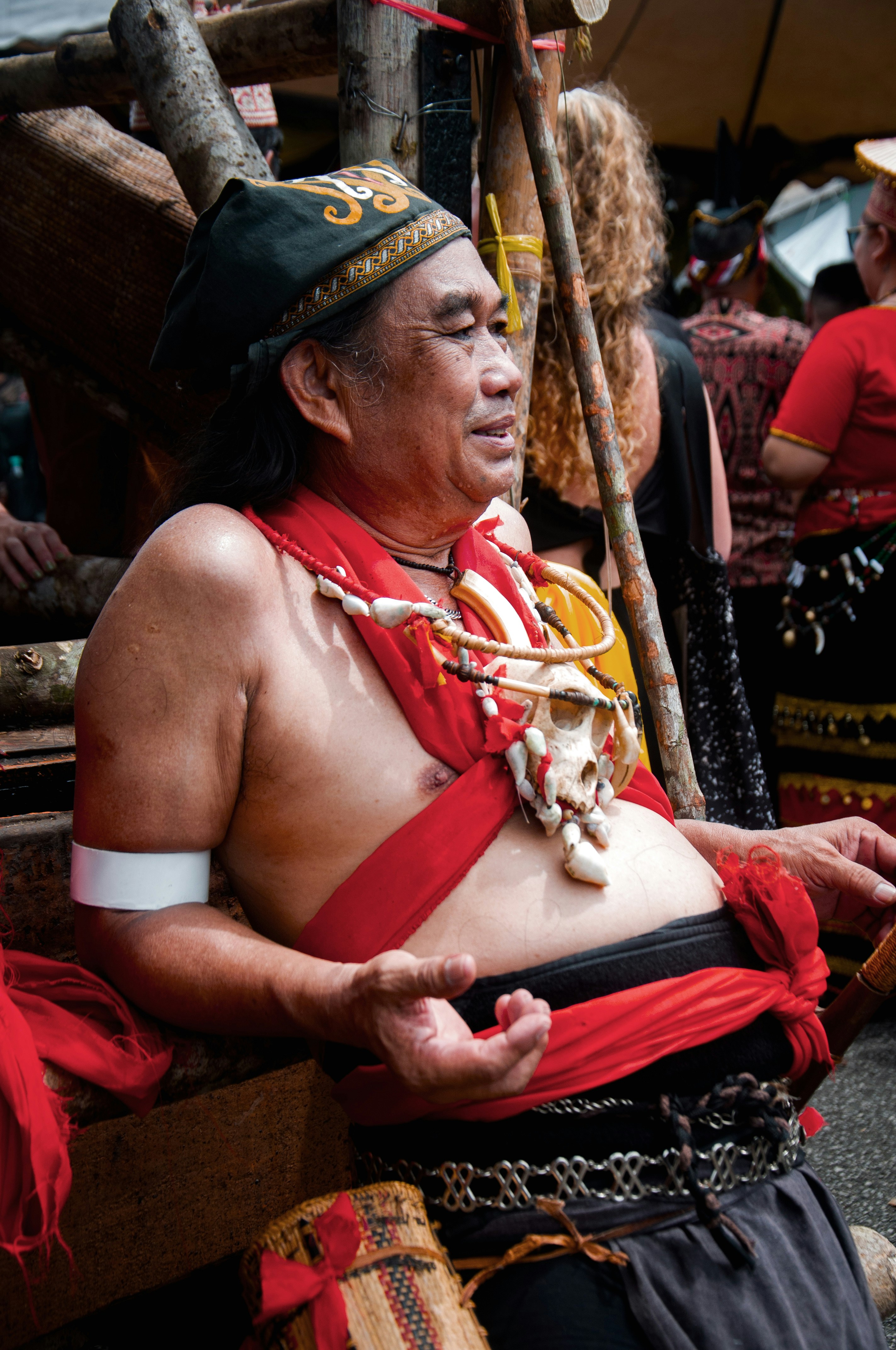 a man in a costume sitting on a bench