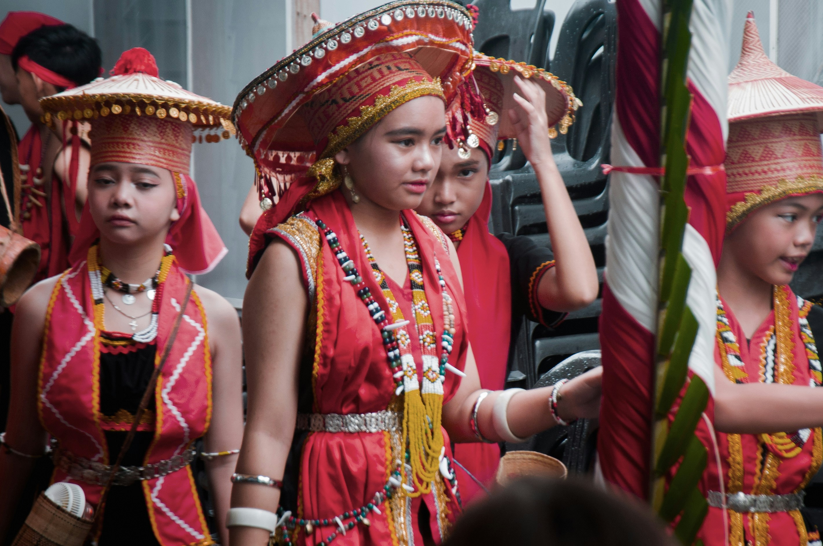 a group of young girls dressed in red and gold