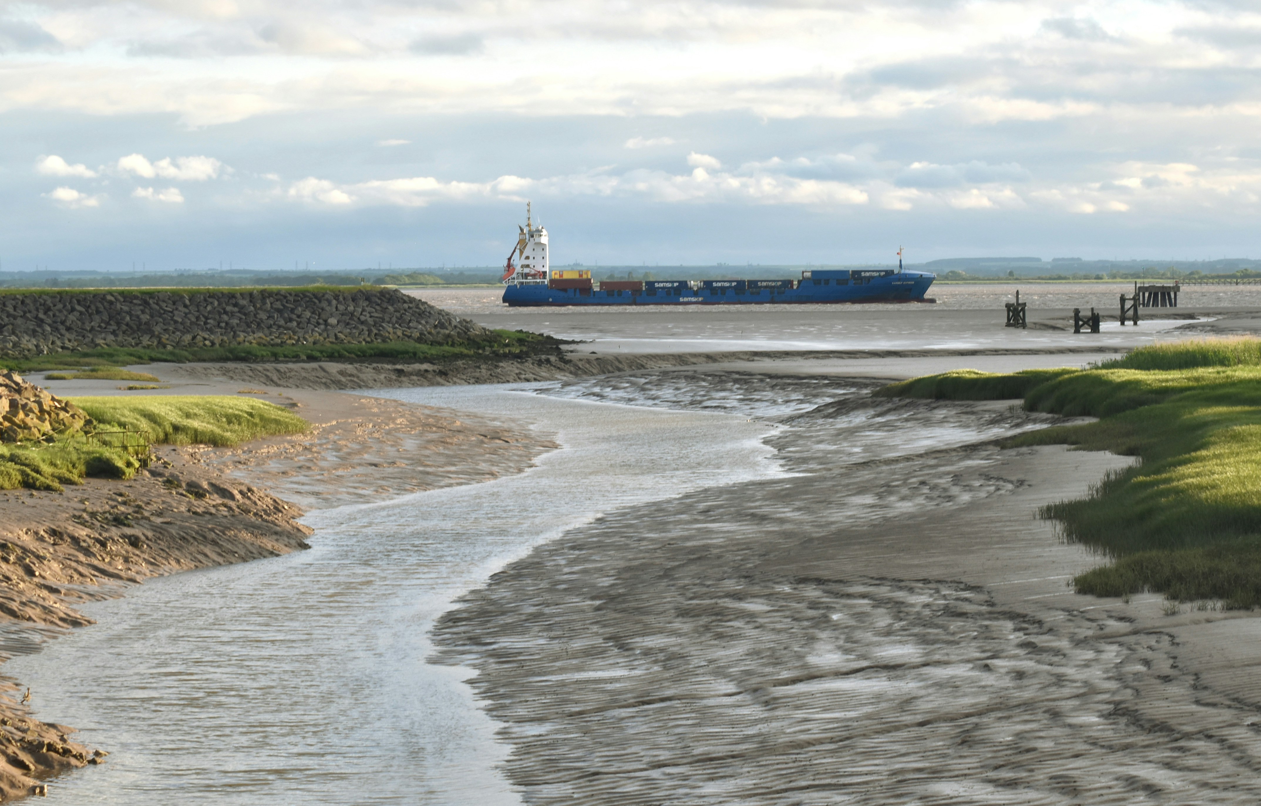 a large cargo ship in the distance on the water