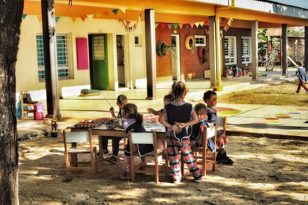 a group of children sitting around a table