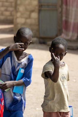 a couple of young boys standing next to each other