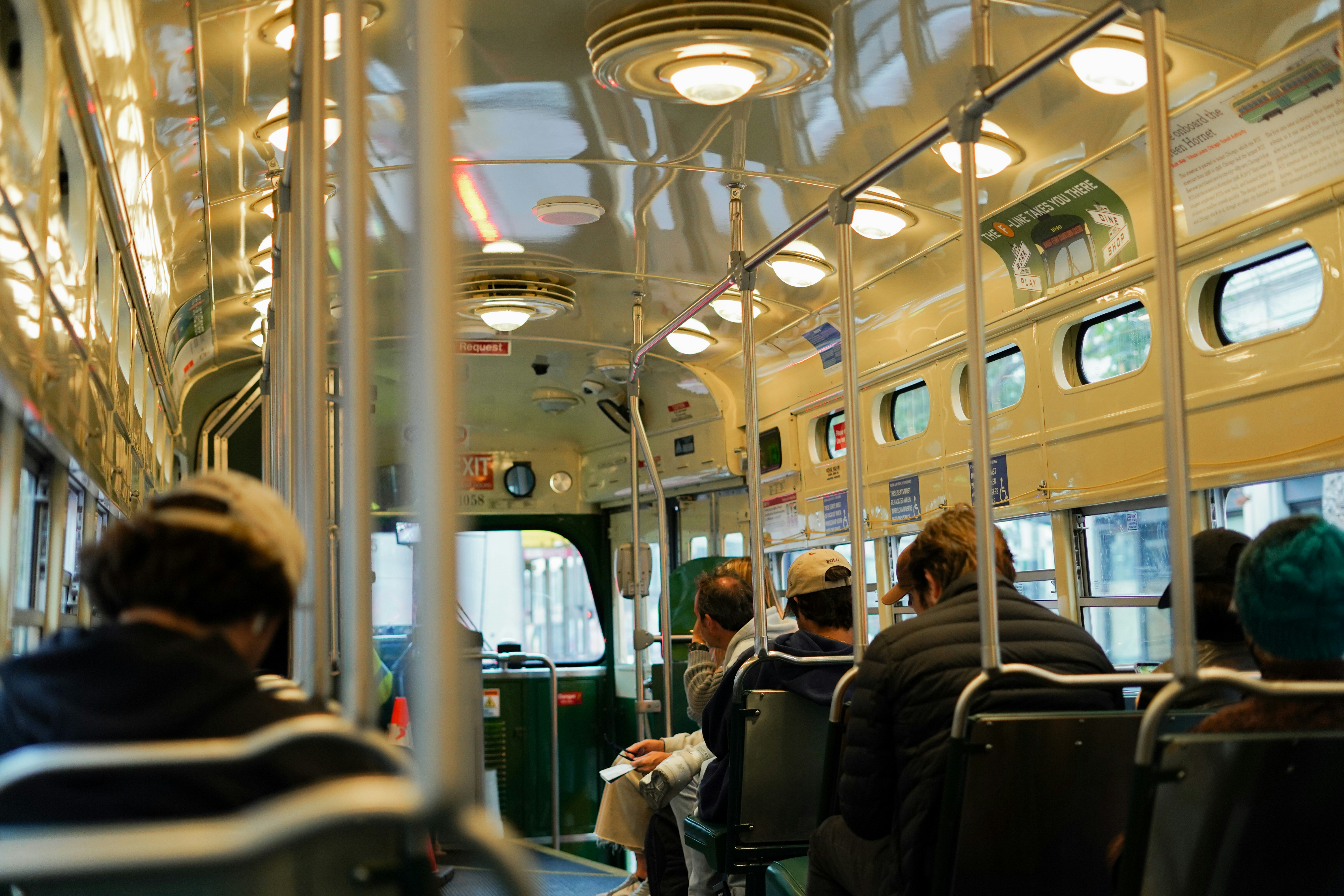 a group of people sitting on a train next to each other