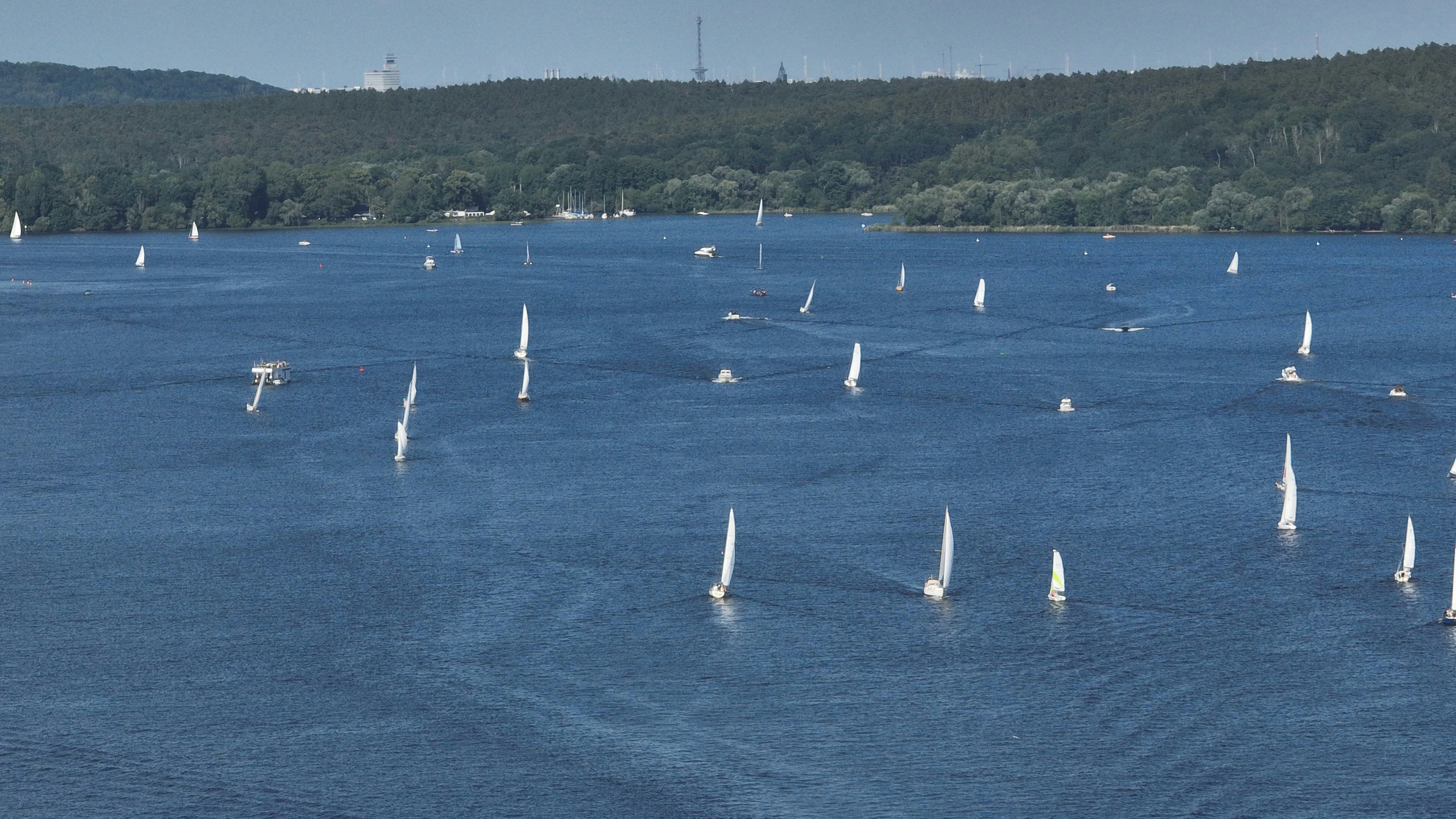 a large body of water filled with lots of sailboats