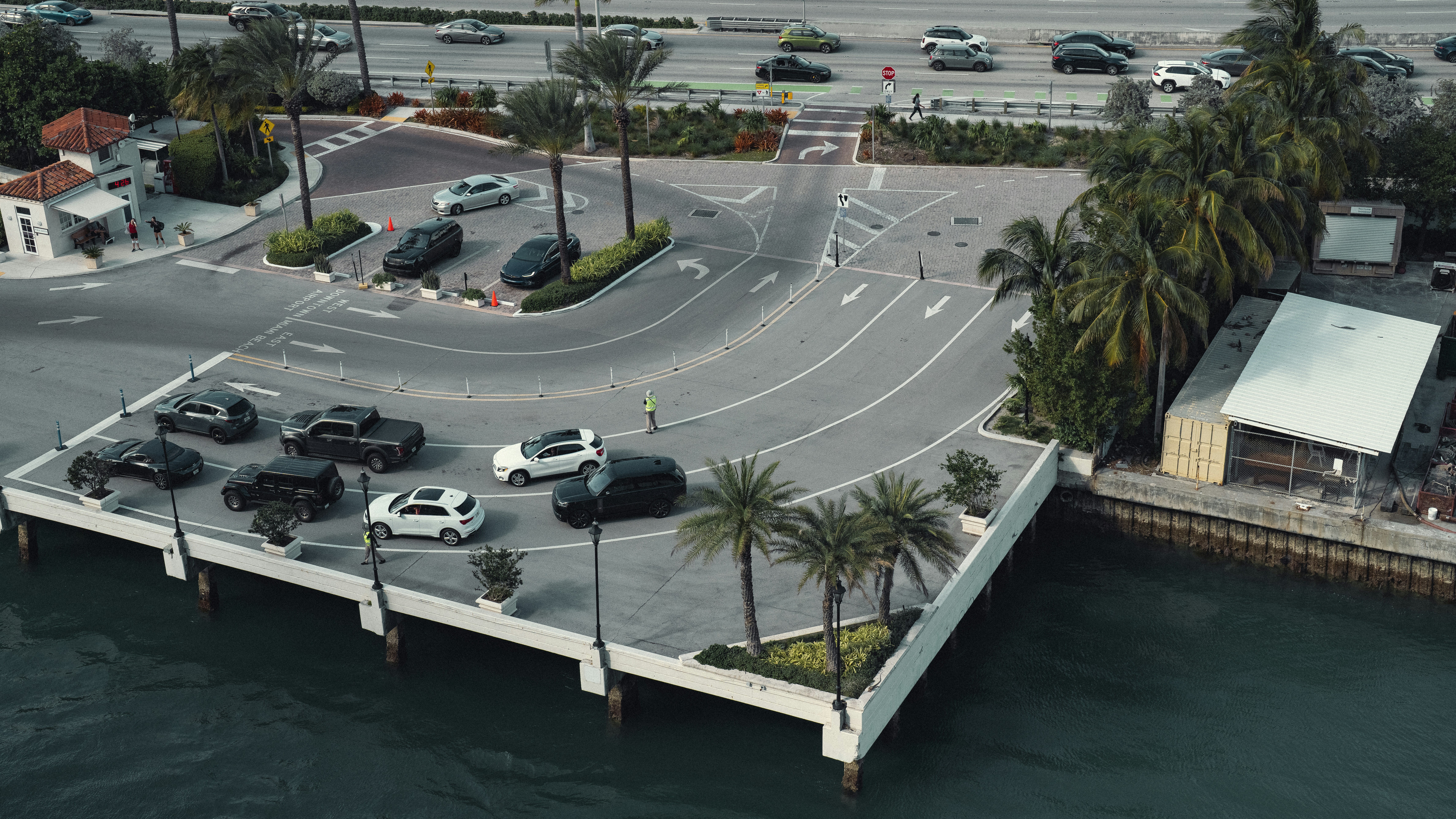 an aerial view of a parking lot next to the ocean
