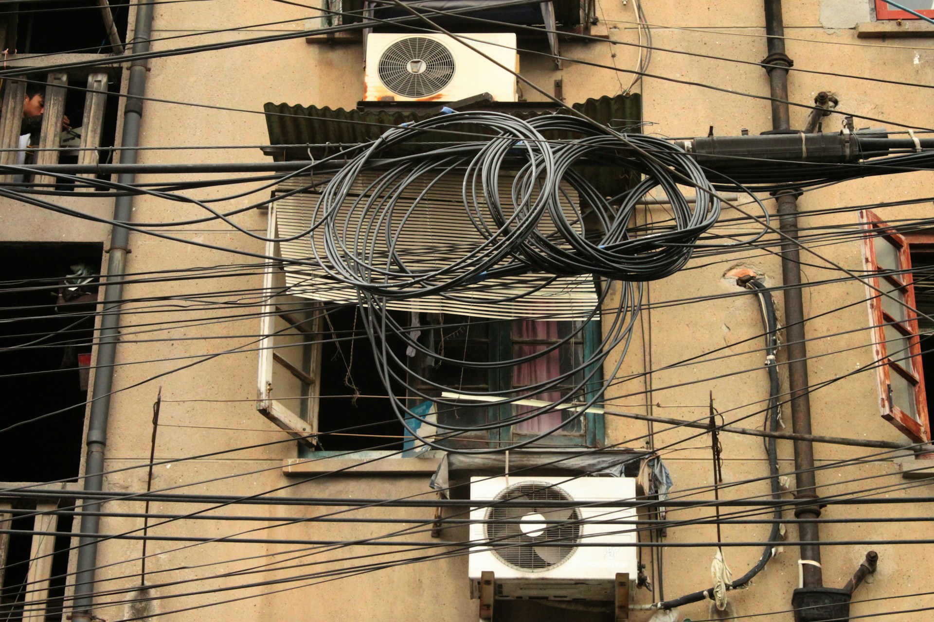 a building with lots of wires hanging from it's sides