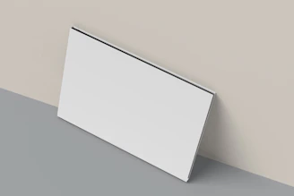 A close up of a white wall with a gray floor