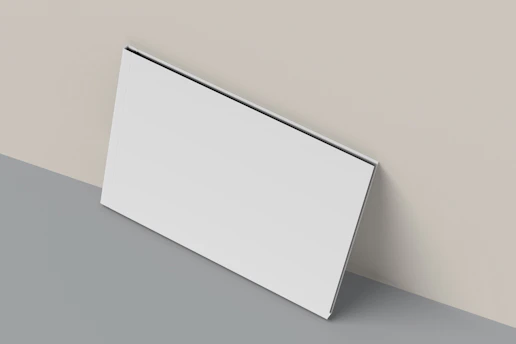 A close up of a white wall with a gray floor