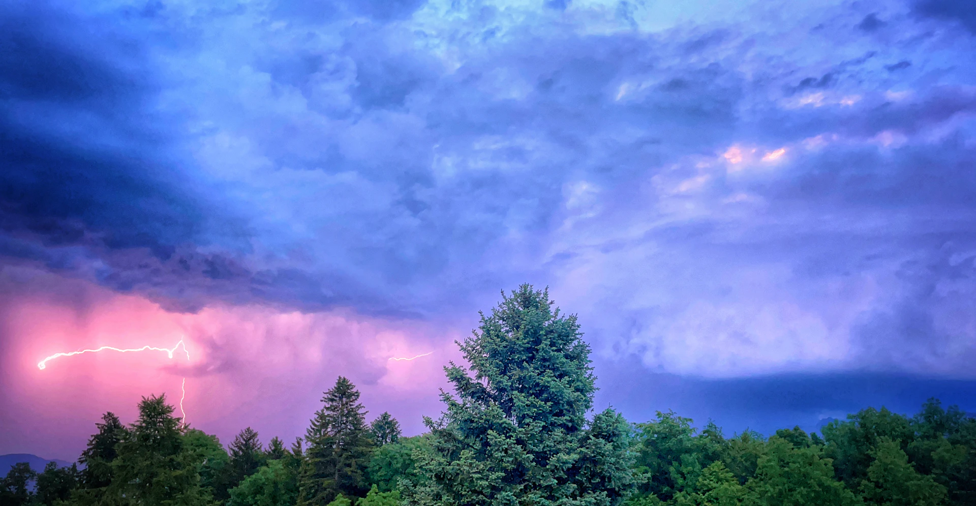 a large cloud with a lightning bolt in the sky