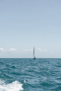a sailboat in the middle of the ocean