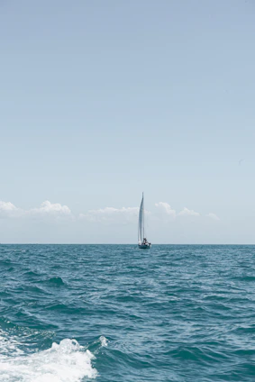 a sailboat in the middle of the ocean