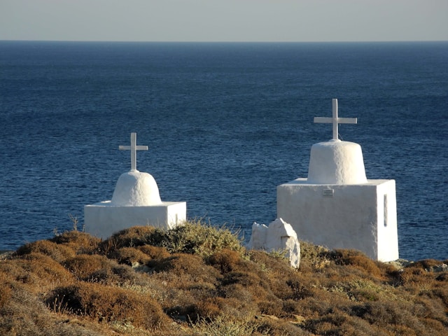 a couple of white buildings sitting on top of a hill