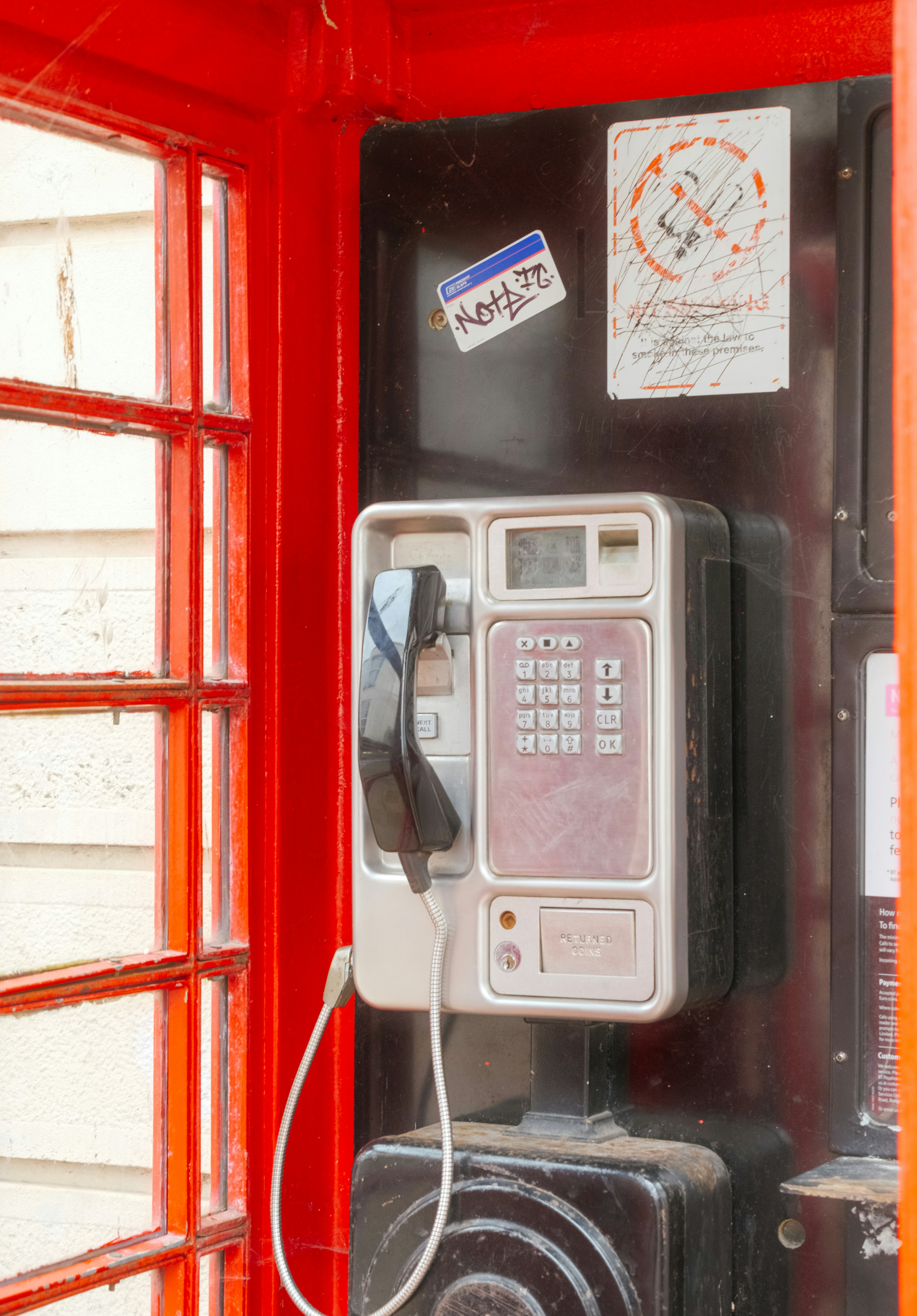 Close-up of a hand using a vintage rotary phone.
