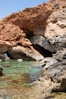 a body of water near a rocky cliff