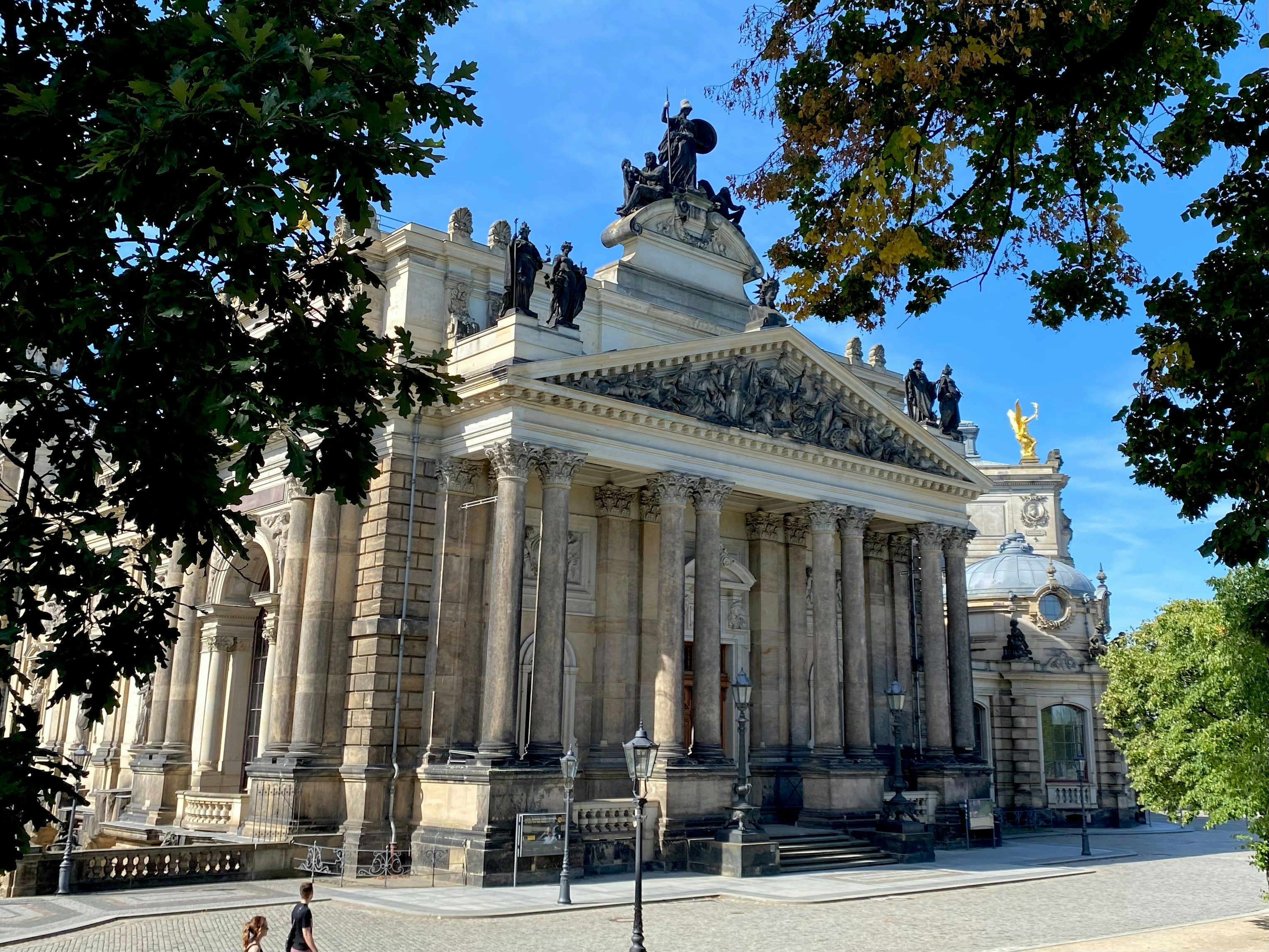 a large building with a statue on top of it