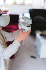 a woman holding a remote control in her hands