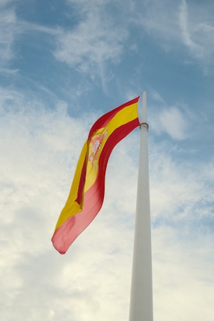a red and yellow flag flying in the wind