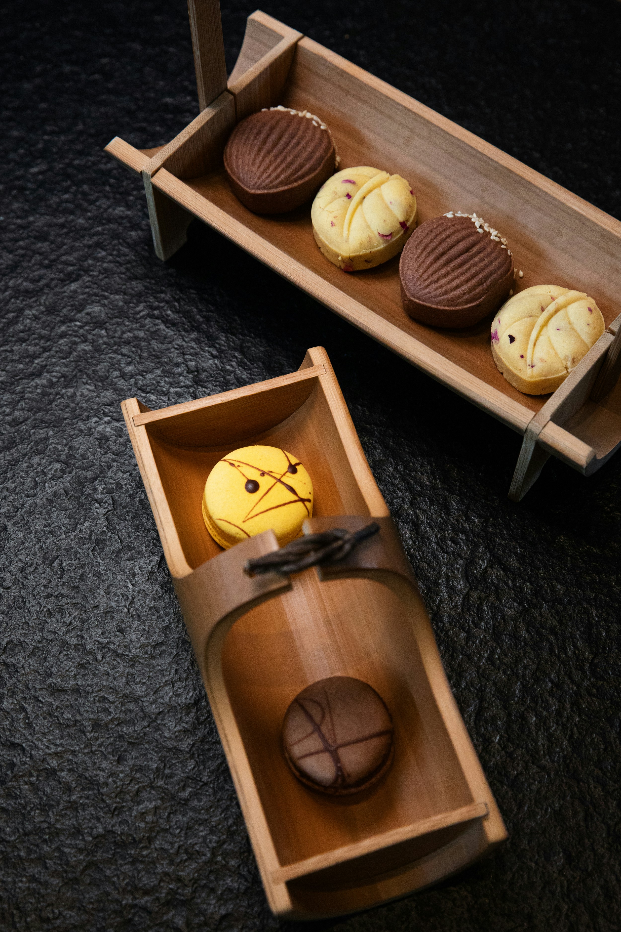 a couple of wooden trays filled with pastries