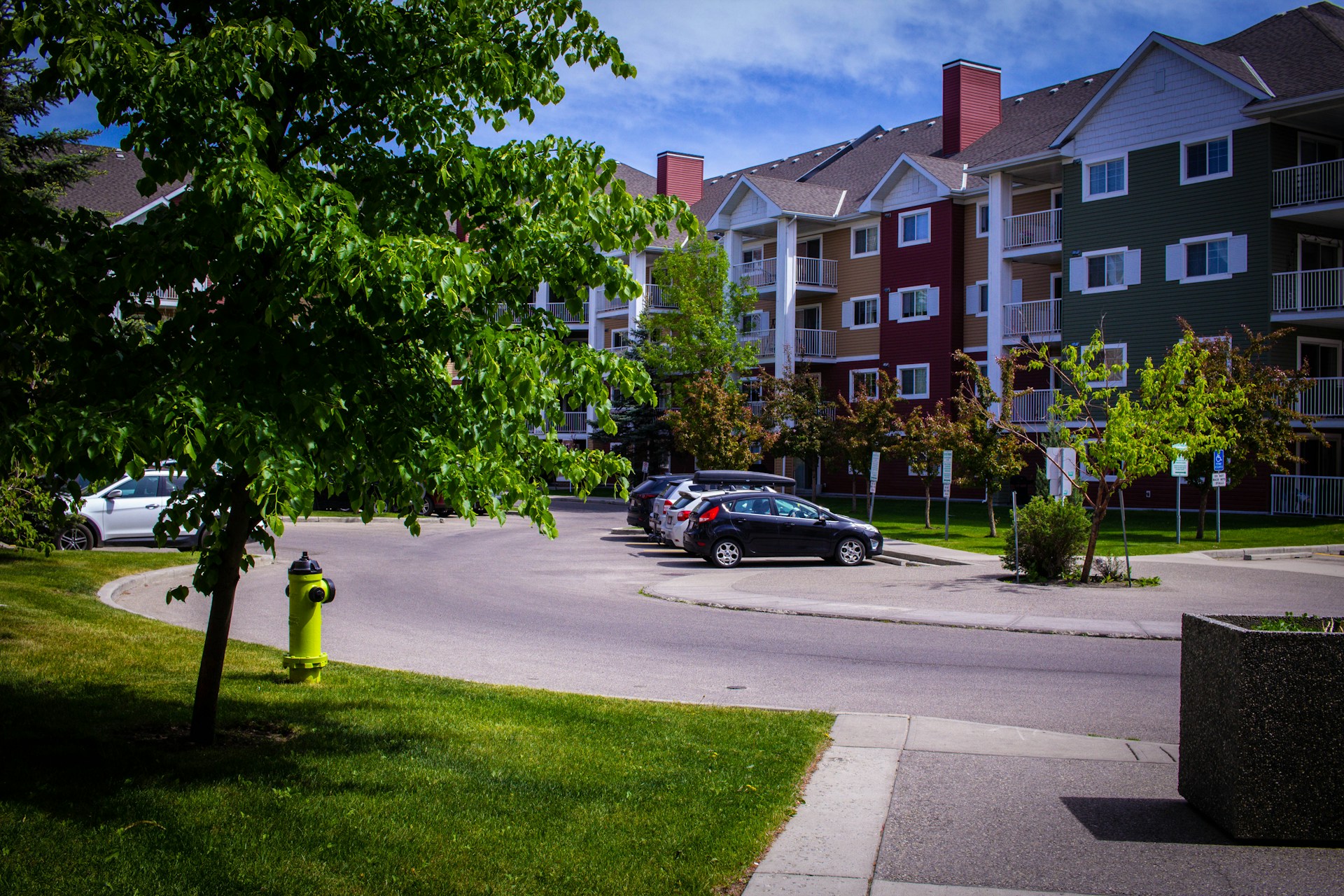 a car parked in a parking lot next to a fire hydrant