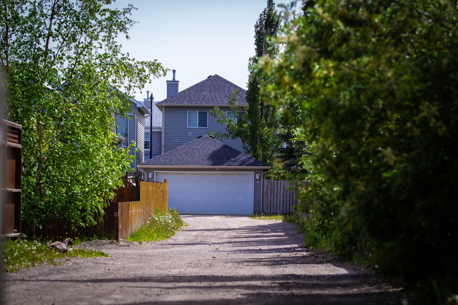 Long driveway leading to suburban garage