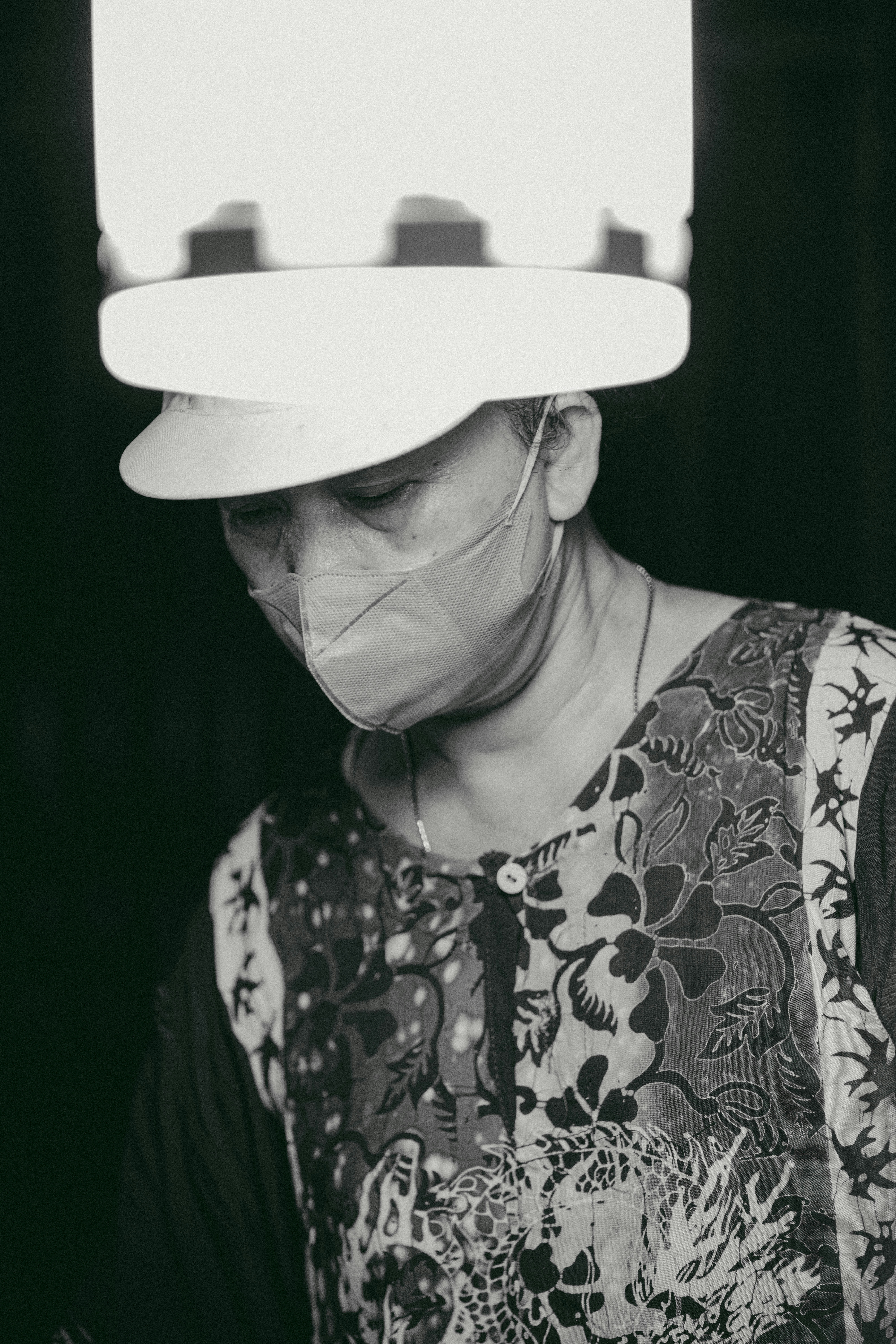 a woman wearing a hat with a light on top of her head