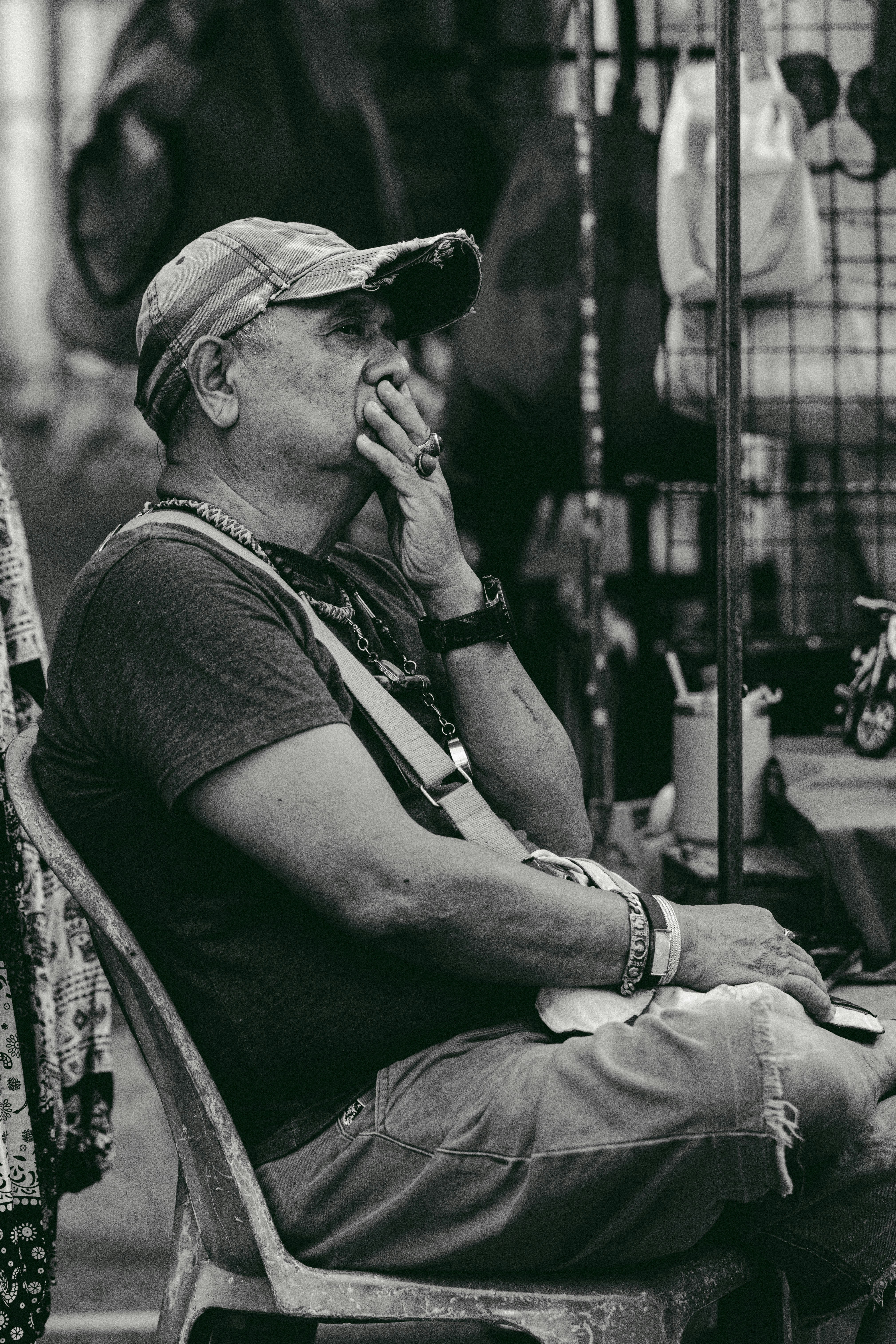 a man sitting in a chair smoking a cigarette