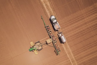 a tractor and a tractor trailer in a field
