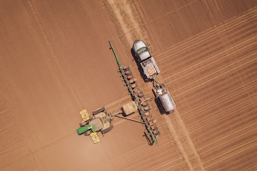 a tractor and a tractor trailer in a field