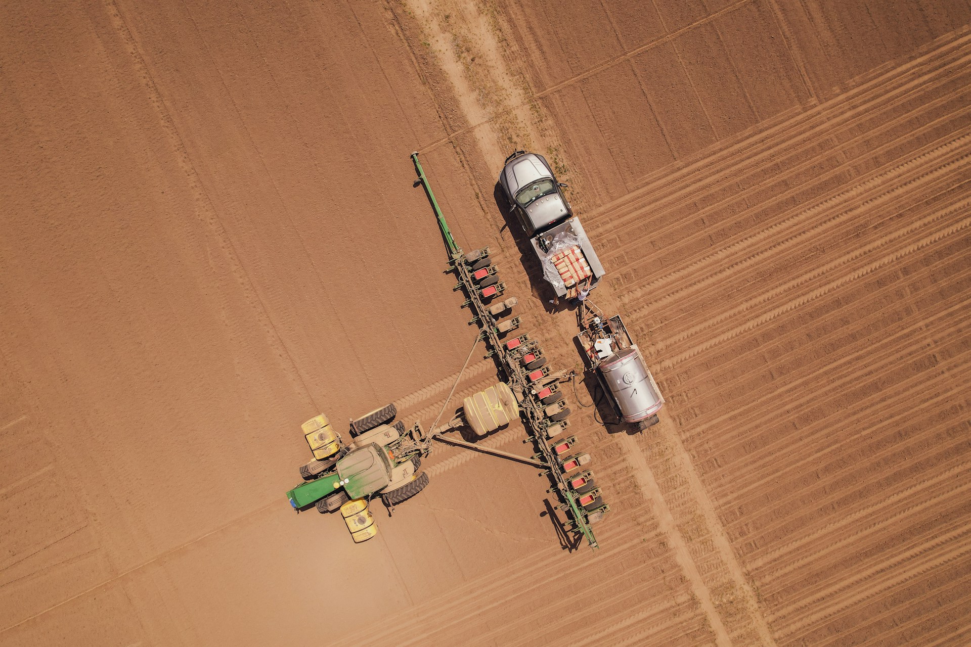 a tractor and a tractor trailer in a field
